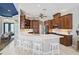 Gourmet kitchen featuring wood cabinetry, quartz countertops, stainless steel appliances, a ceiling fan, and a center island at 12 Medalist Ter, Rotonda West, FL 33947