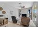 Comfortable living room with modern furniture, a TV, desk and large sliding glass doors, offering a seamless transition outdoors at 12 Medalist Ter, Rotonda West, FL 33947