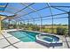 Inviting in-ground pool featuring a jacuzzi and lush landscaping at 12 Medalist Ter, Rotonda West, FL 33947