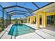 Screened-in pool and jacuzzi with a covered patio area at 12 Medalist Ter, Rotonda West, FL 33947