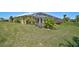 View of pool, lanai, and flower garden from the large backyard of home at 12 Medalist Ter, Rotonda West, FL 33947