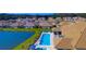Aerial view of community featuring a swimming pool, lake and many single-Gathering homes at 1214 Godavari Way, Wesley Chapel, FL 33543