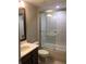 Well-lit bathroom with tile surround tub, dark cabinets, and bright vanity, creating a clean and functional space at 1214 Godavari Way, Wesley Chapel, FL 33543