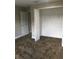 Bedroom featuring an open closet and neutral decor, providing a serene and customizable living space at 1214 Godavari Way, Wesley Chapel, FL 33543