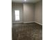 A spacious bedroom with plush carpeting and a large bright window at 1214 Godavari Way, Wesley Chapel, FL 33543
