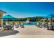 Resort-style pool area with comfortable seating and lush scenery, perfect for relaxation and social gatherings at 1214 Godavari Way, Wesley Chapel, FL 33543