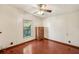 Cozy bedroom featuring hardwood floors and a large window with natural light at 12519 Cambridge Ave, Tampa, FL 33624