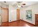 Bright bedroom featuring wood-look floors, ceiling fan, and a window with lots of natural light at 12519 Cambridge Ave, Tampa, FL 33624