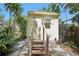 Exterior view of storage unit with steps and mature landscaping at 12519 Cambridge Ave, Tampa, FL 33624
