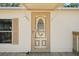 A close-up of the home's front door and shuttered window at 12519 Cambridge Ave, Tampa, FL 33624