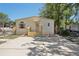 Home features a large parking pad with front entrance and awning at 12519 Cambridge Ave, Tampa, FL 33624