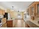 Bright kitchen featuring granite countertops and wood cabinetry with glass doors at 12519 Cambridge Ave, Tampa, FL 33624