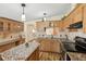 A kitchen featuring wood cabinets, granite counters, and stainless steel appliances at 12519 Cambridge Ave, Tampa, FL 33624
