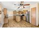 An open-concept kitchen featuring a center island, stainless steel appliances, and wood cabinets at 12519 Cambridge Ave, Tampa, FL 33624
