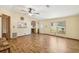 Inviting living room with wood flooring, ceiling fan, and lots of natural light at 12519 Cambridge Ave, Tampa, FL 33624