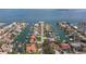 A serene aerial view shows the home's waterfront location with access to open water and boat docks at 137 11Th E St, Tierra Verde, FL 33715