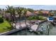 Aerial view of a waterfront home featuring a pool, screened-in patio, boat, and a private dock at 137 11Th E St, Tierra Verde, FL 33715