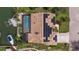 Aerial view of home with solar panels, pool, dock, and waterfront access to the canal at 137 11Th E St, Tierra Verde, FL 33715