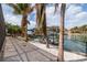 Waterfront home featuring mature palm trees and rock landscaping leading to the boat dock at 137 11Th E St, Tierra Verde, FL 33715