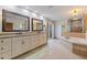 Well-lit bathroom with double vanity, separate tub, and glass-enclosed shower at 137 11Th E St, Tierra Verde, FL 33715