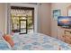 Comfortable bedroom featuring a waterfront view, a decorative bedspread, and a flat screen TV at 137 11Th E St, Tierra Verde, FL 33715