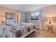 Cozy bedroom featuring a floral comforter, white dresser with TV, and a sunny window at 137 11Th E St, Tierra Verde, FL 33715