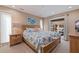 Bright bedroom showcasing a decorative bedspread, neutral walls, and a sliding glass door to the lanai at 137 11Th E St, Tierra Verde, FL 33715