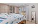 Charming bedroom with built-in shelves, a decorative comforter, and a bright window at 137 11Th E St, Tierra Verde, FL 33715