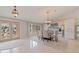 Elegant dining room featuring a glass table, upholstered chairs, decorative lighting, and marble floors at 137 11Th E St, Tierra Verde, FL 33715