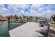 Waterfront home featuring a private boat dock with seating, boat lift, and stunning water views at 137 11Th E St, Tierra Verde, FL 33715