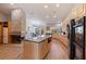 Spacious kitchen featuring wood cabinets, stainless appliances, large center island, and fireplace at 137 11Th E St, Tierra Verde, FL 33715