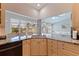 Kitchen with light wood cabinets, granite countertops, and an open view to the living area at 137 11Th E St, Tierra Verde, FL 33715