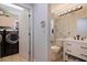 Convenient laundry room adjacent to the bathroom with modern washer and dryer at 137 11Th E St, Tierra Verde, FL 33715