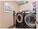 Bright laundry room with modern front-load washer and dryer at 137 11Th E St, Tierra Verde, FL 33715