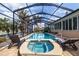 Beautiful screened pool area features a jacuzzi tub and waterfront views at 137 11Th E St, Tierra Verde, FL 33715