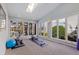 Bright sun room with gym equipment and views of the water at 137 11Th E St, Tierra Verde, FL 33715
