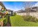 Well-maintained backyard featuring a covered patio, green lawn, and privacy fence at 1435 Montgomery Bell Rd, Wesley Chapel, FL 33543