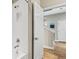 Bright bathroom featuring white tiled shower and an open doorway to the hallway at 1435 Montgomery Bell Rd, Wesley Chapel, FL 33543