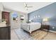 Cozy bedroom with a queen bed, blue accent wall, and coordinated decor at 1435 Montgomery Bell Rd, Wesley Chapel, FL 33543