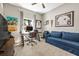 Comfortable bedroom with a desk, a blue sofa, and a large window at 1435 Montgomery Bell Rd, Wesley Chapel, FL 33543