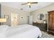 Spacious bedroom with ceiling fan, dresser, and ensuite bathroom at 1435 Montgomery Bell Rd, Wesley Chapel, FL 33543