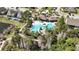 Aerial view of a resort-style pool surrounded by trees, amenities and lounge areas at 1435 Montgomery Bell Rd, Wesley Chapel, FL 33543
