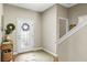Welcoming foyer with a patterned front door, wood floors, and a staircase, creating an inviting entrance at 1435 Montgomery Bell Rd, Wesley Chapel, FL 33543