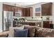Modern kitchen featuring stainless steel appliances, granite countertops, and dark wood cabinets at 1435 Montgomery Bell Rd, Wesley Chapel, FL 33543