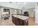 Open-concept kitchen featuring an island, granite countertops, and stainless steel appliances at 1435 Montgomery Bell Rd, Wesley Chapel, FL 33543