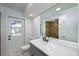 Beautiful bathroom featuring a large mirror, white countertop and gray vanity, and shower with stone tile at 1465 40Th Ne Ave, St Petersburg, FL 33703