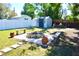 Well maintained backyard features a fire pit with benches, storage shed, and pristine lawn at 1509 Lemon St, Clearwater, FL 33756