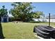 This spacious backyard features a pristine lawn, convenient storage shed, and cozy fire pit at 1509 Lemon St, Clearwater, FL 33756