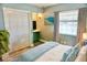Calm bedroom with large window, soft blue accent pillows, and a full closet offers a peaceful retreat at 1509 Lemon St, Clearwater, FL 33756