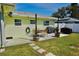 Outdoor patio includes dining set, grill and landscaped garden for relaxing experience at 1509 Lemon St, Clearwater, FL 33756